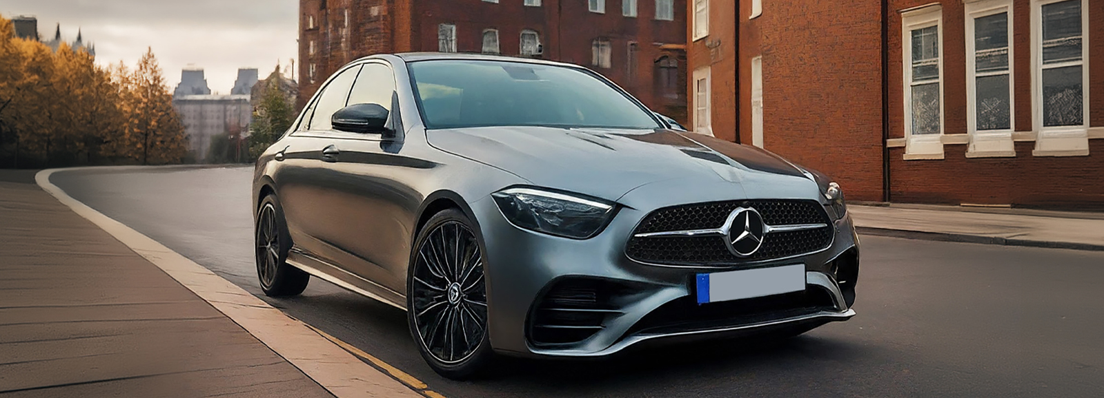 A Silver Luxury Mercedes car parked on the side of the road